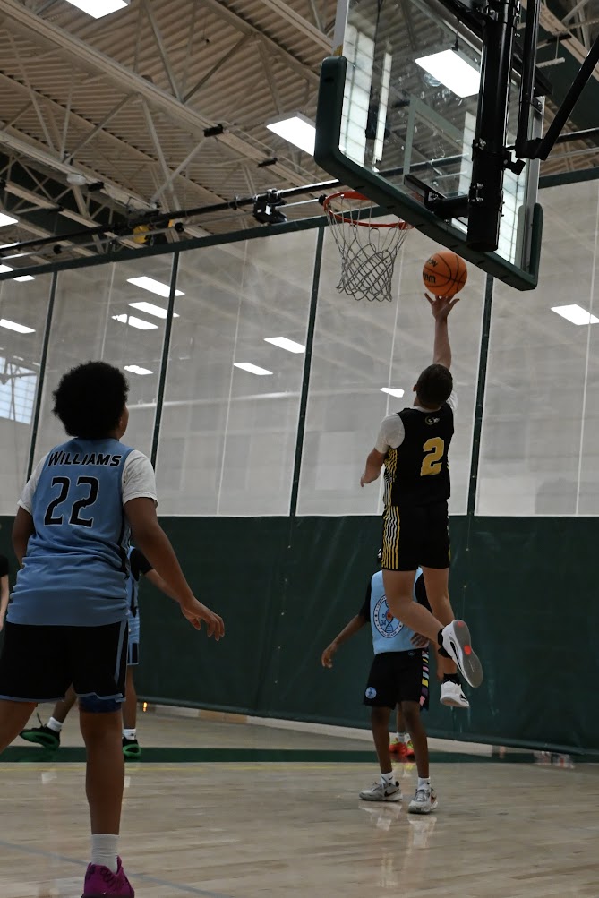 Landon Neuenschwander on defense during a basketball game.
