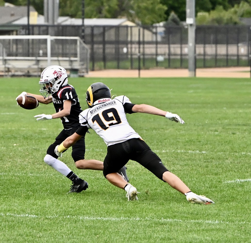 Landon Neuenschwander playing defense during a football game.